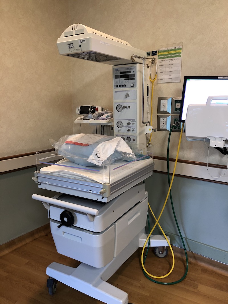 Heated bassinet infant warmer in hospital delivery room